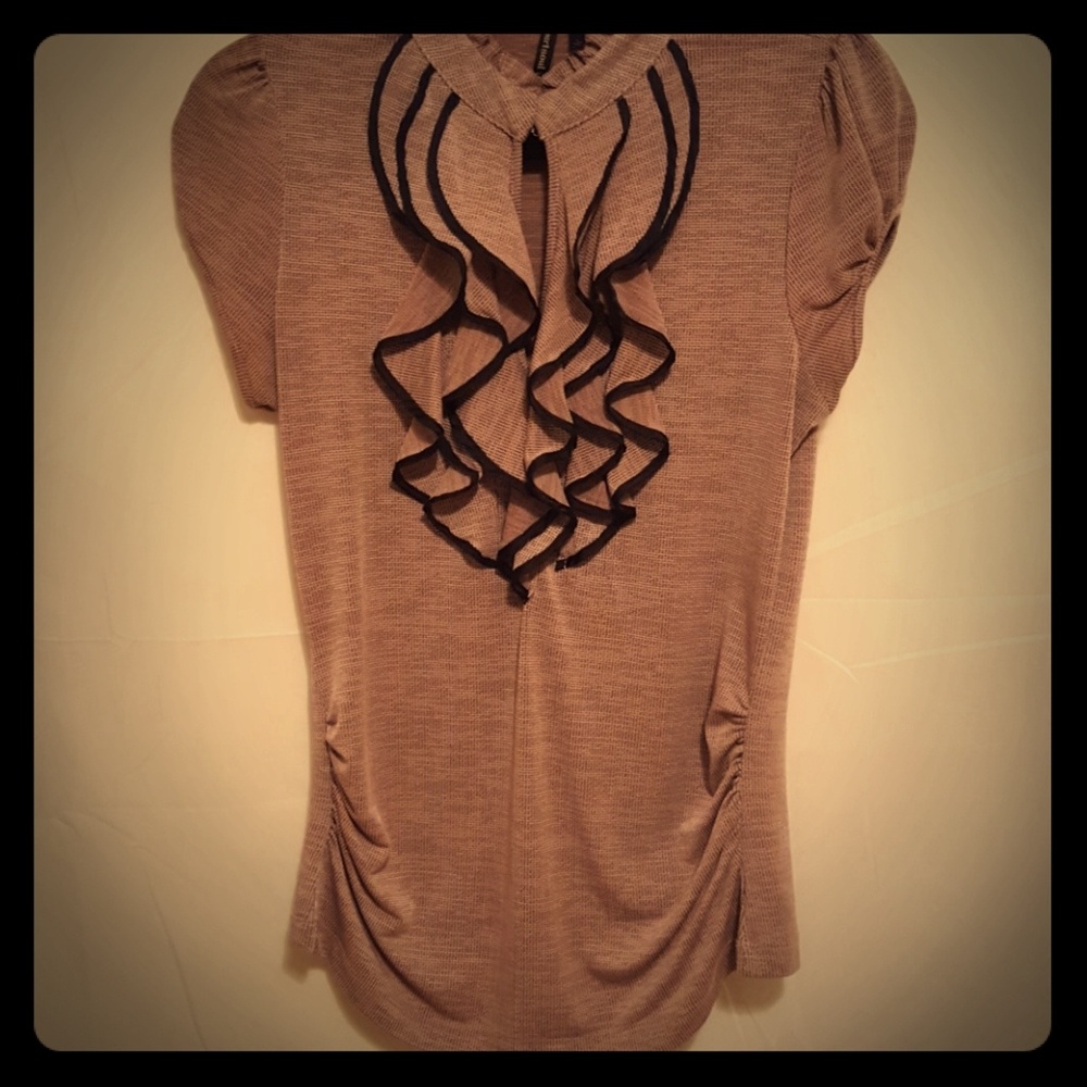 Mauve knit shirt with black edged ruffles.